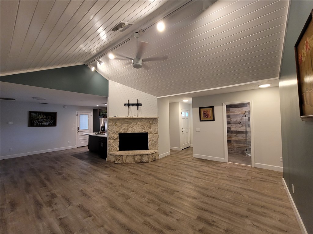 6515 5th Street Vero Beach, FL 32968 - Photo 17 of 36 an empty room with wooden floor fireplace and windows