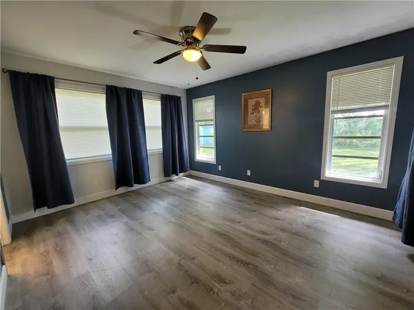 a view of a livingroom with a window and a ceiling fan