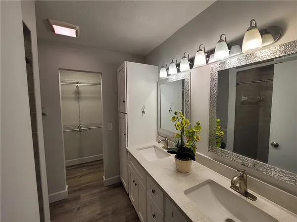 a bathroom with a granite countertop shower and a toilet