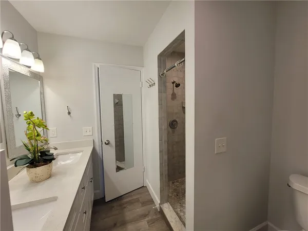 a bathroom with double vanity sinks and a mirror