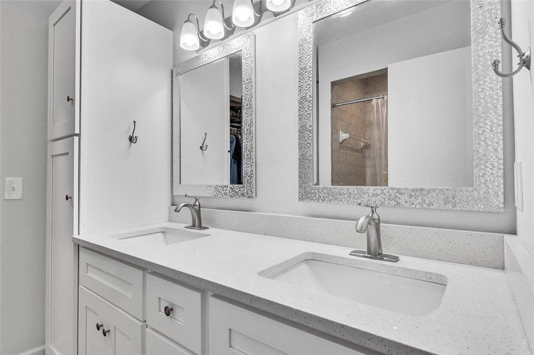 6515 5th Street Vero Beach, FL 32968 - Photo 26 of 36 a bathroom with double vanity sinks and a mirror