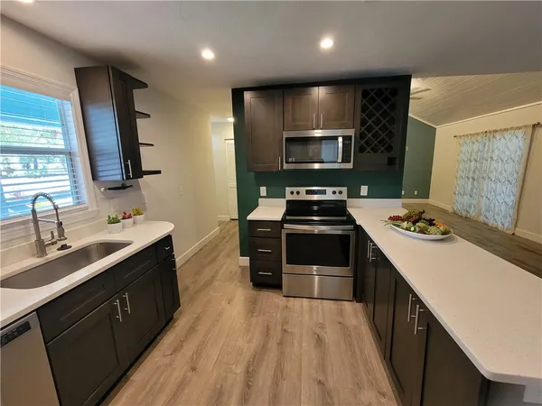 a kitchen with stainless steel appliances a refrigerator and a stove