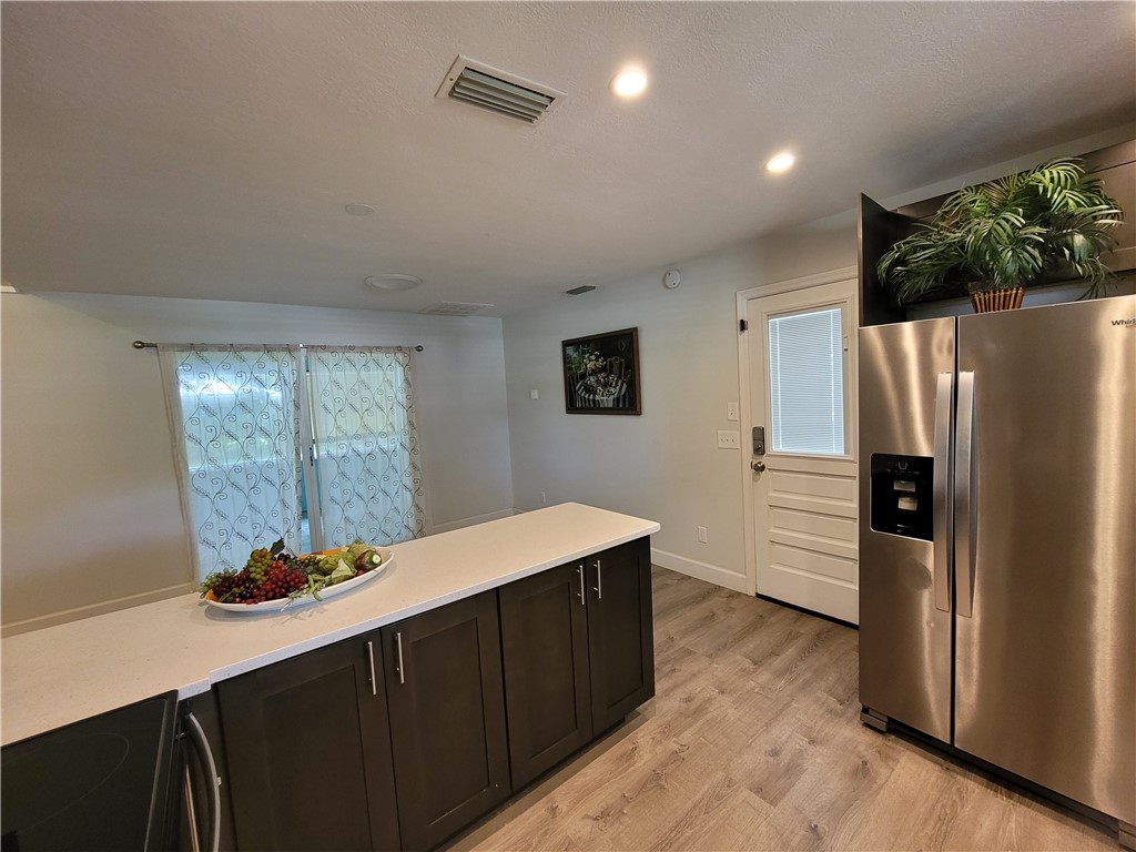 6515 5th Street Vero Beach, FL 32968 - Photo 9 of 36 a kitchen with stainless steel appliances a refrigerator and a stove