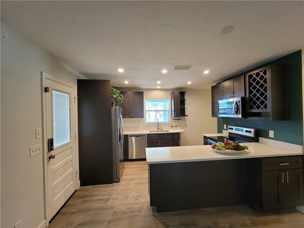 6515 5th Street Vero Beach, FL 32968 - Photo 10 of 36 a kitchen with a refrigerator and a sink