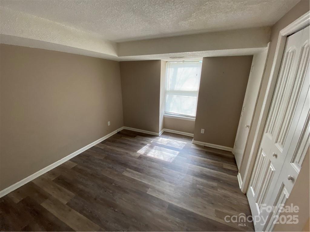 9325 Old Concord Road, Unit F Charlotte, NC 28213 - Photo 7 of 9 an empty room with wooden floor and windows