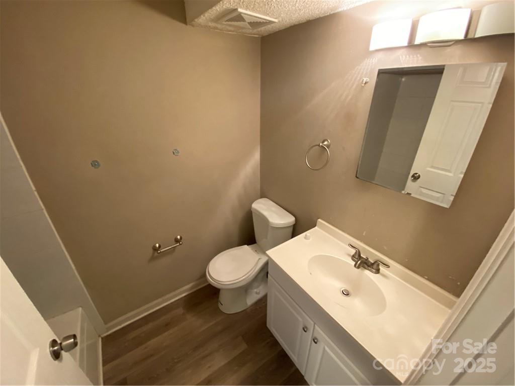 9325 Old Concord Road, Unit F Charlotte, NC 28213 - Photo 8 of 9 a bathroom with a sink and mirror with toilet
