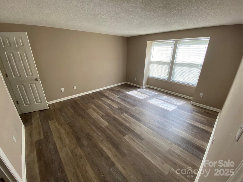 9325 Old Concord Road, Unit F Charlotte, NC 28213 - Photo 9 of 9 a view of an empty room with wooden floor and a window