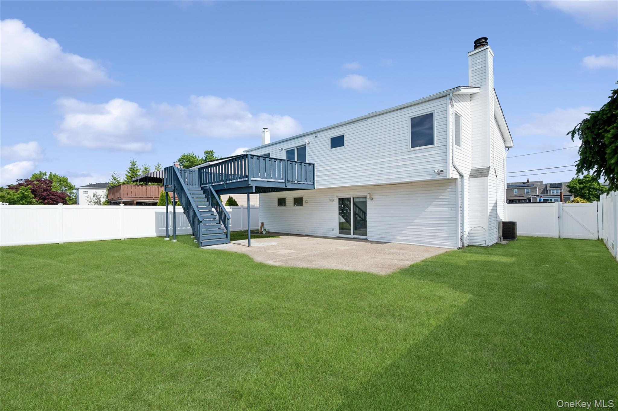 2625 Riverside Drive Wantagh, NY 11793 - Photo 3 of 20 a front view of a house with a yard and garage