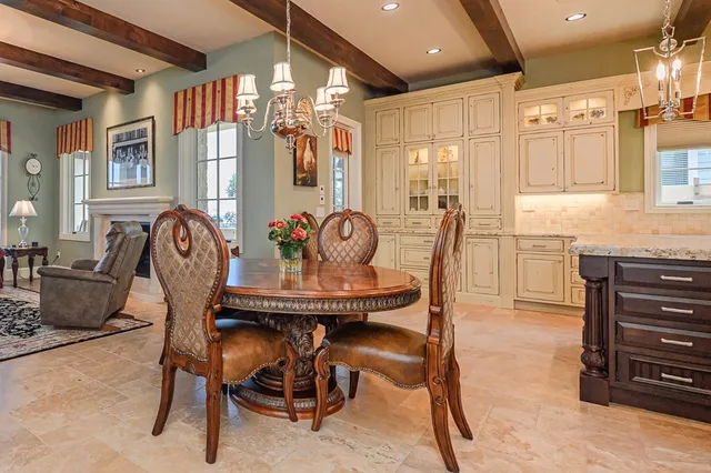 a view of a dining room with furniture and chandelier