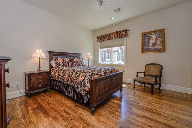 a bedroom with bed and a chandelier