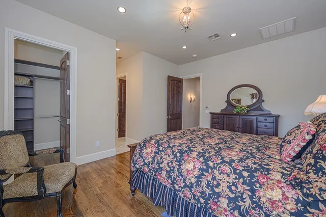 a en suite bathroom with a granite countertop sink and a mirror