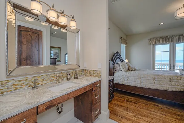 a large kitchen with stainless steel appliances double vanity and a sink