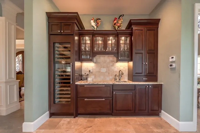 a bathroom with a granite countertop sink a toilet and a mirror