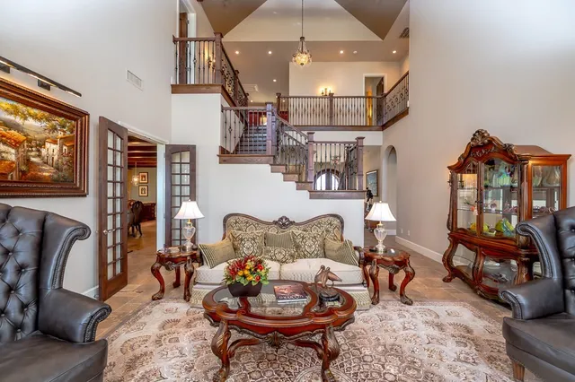 a living room with furniture large window and a fireplace