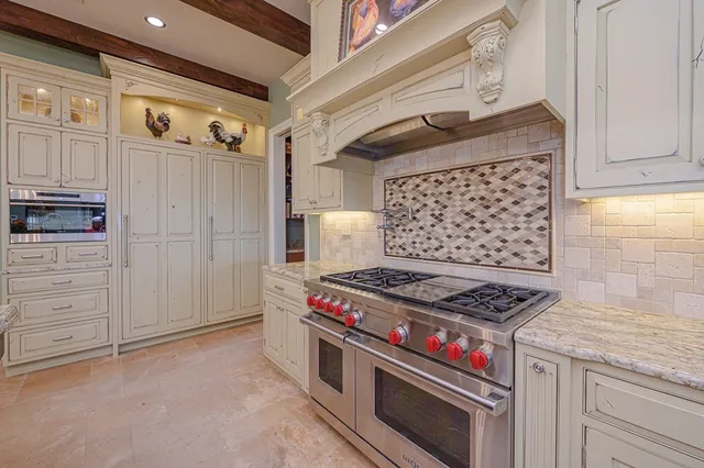 a stove top oven sitting inside of a kitchen