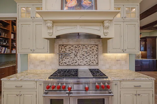 a bathroom with a granite countertop sink a large mirror and a shower