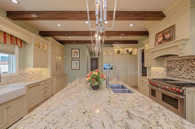 a kitchen with sink stove and cabinets