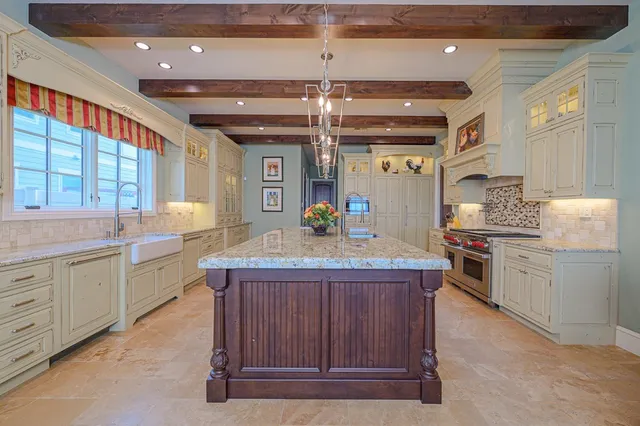 a kitchen with stainless steel appliances granite countertop a stove and a sink
