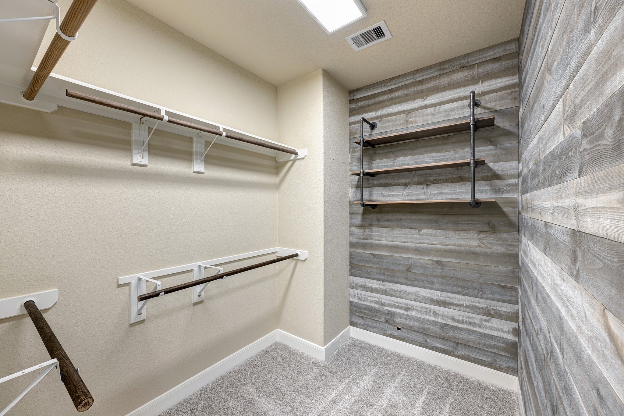 11 Red Wagon Drive Spring, TX 77389 - Photo 17 of 31 The primary closet continues with an abundance of hanging space and a wood paneled accent wall.