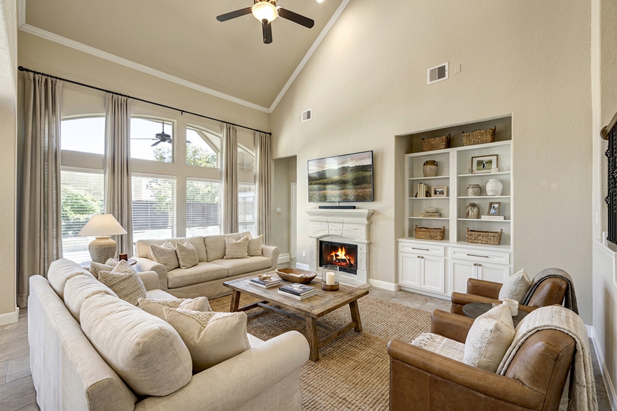 11 Red Wagon Drive Spring, TX 77389 - Photo 6 of 31 The two-story family room is filled with natural light from a wall of windows! Gas log fireplace has a cast stone surround and mantle. Photo is virtually furnished.