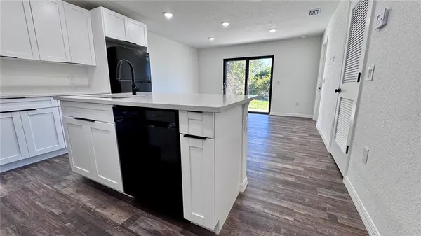 a kitchen with a refrigerator and a sink