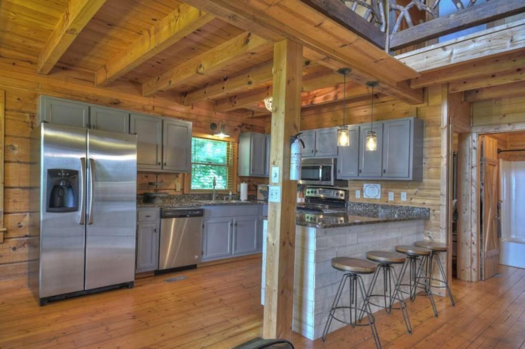 181 Ridge Circle Blue Ridge, GA 30513 - Photo 14 of 59 a kitchen with stainless steel appliances granite countertop a refrigerator and a stove top oven