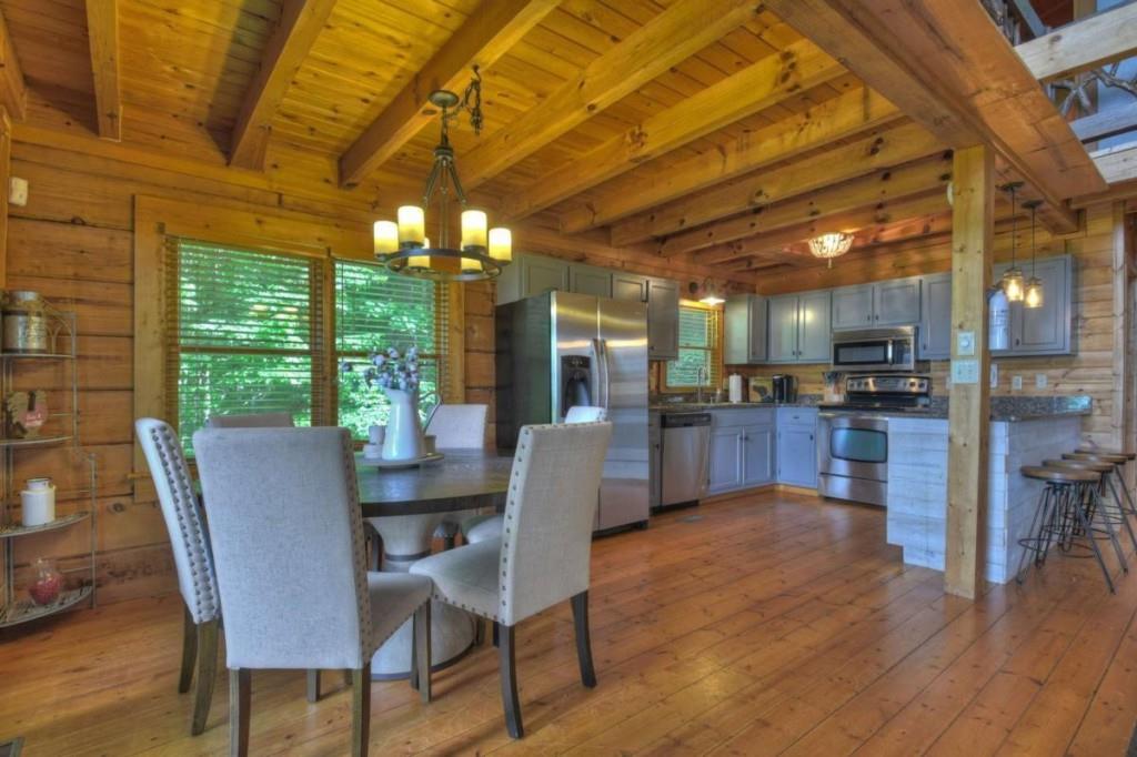 181 Ridge Circle Blue Ridge, GA 30513 - Photo 15 of 59 a dining room with furniture a kitchen view and a chandelier