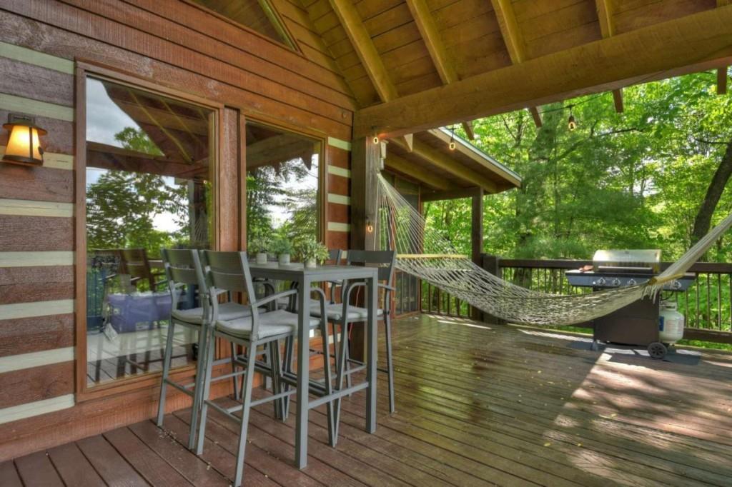 181 Ridge Circle Blue Ridge, GA 30513 - Photo 19 of 59 a view of a chairs and table in patio with a backyard