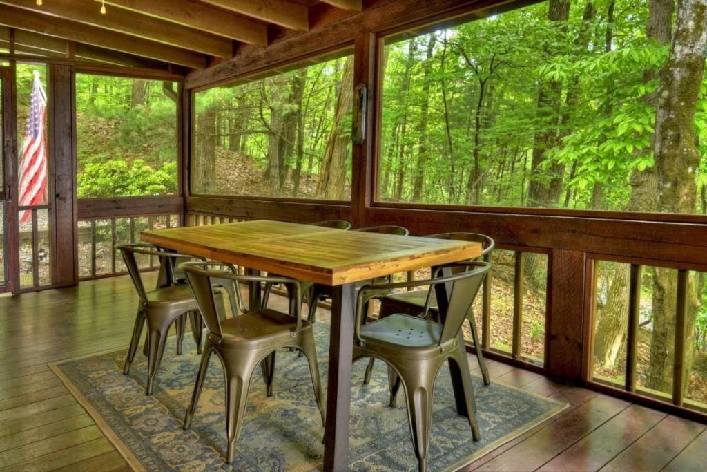 181 Ridge Circle Blue Ridge, GA 30513 - Photo 21 of 59 a table and chairs with wooden floor in front of the house