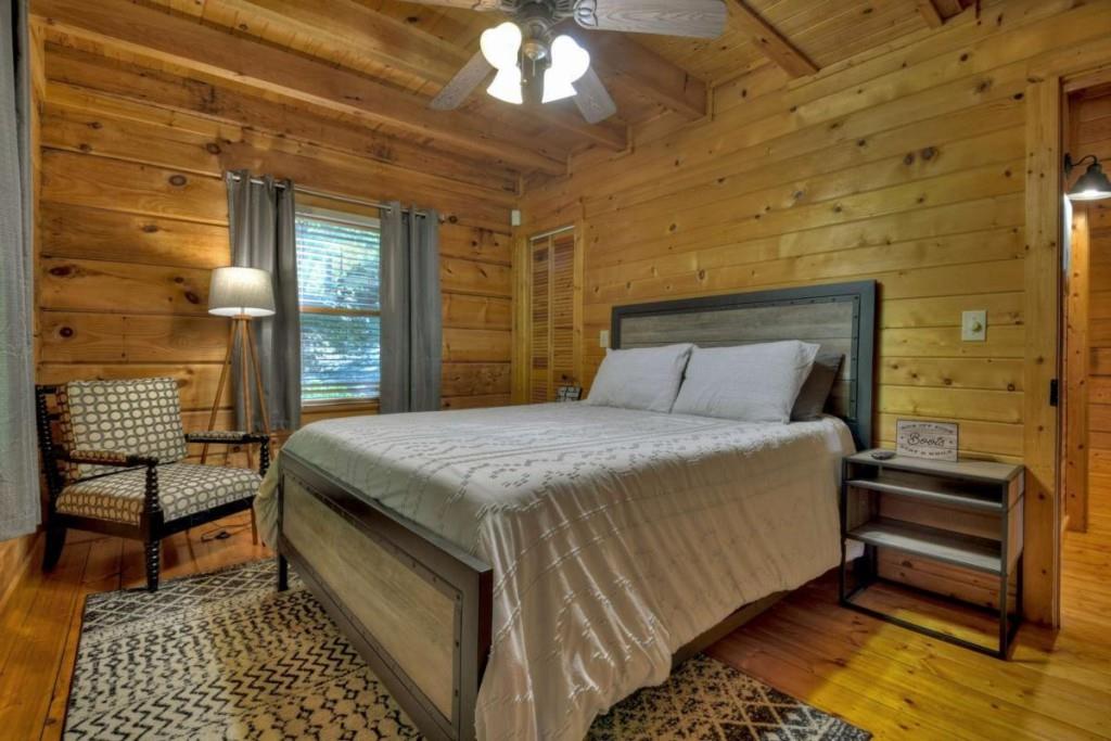 181 Ridge Circle Blue Ridge, GA 30513 - Photo 26 of 59 a bedroom with a bed and wooden floor