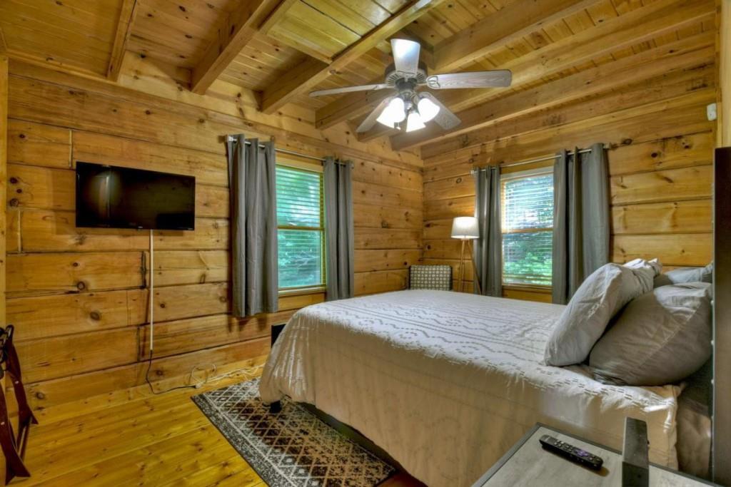 181 Ridge Circle Blue Ridge, GA 30513 - Photo 27 of 59 a bedroom with a bed and a flat screen tv