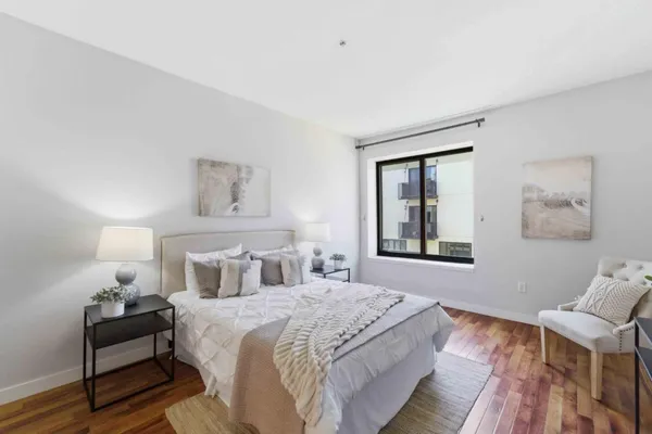 a bedroom with bed and window