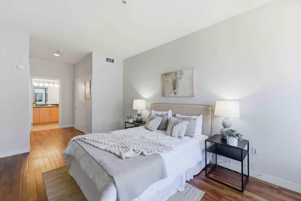 a bedroom with a bed and a lamp