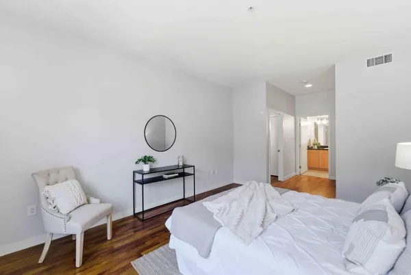 a bedroom with a bed and a chair