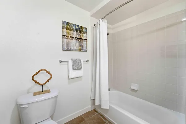 a bathroom with a toilet sink and shower