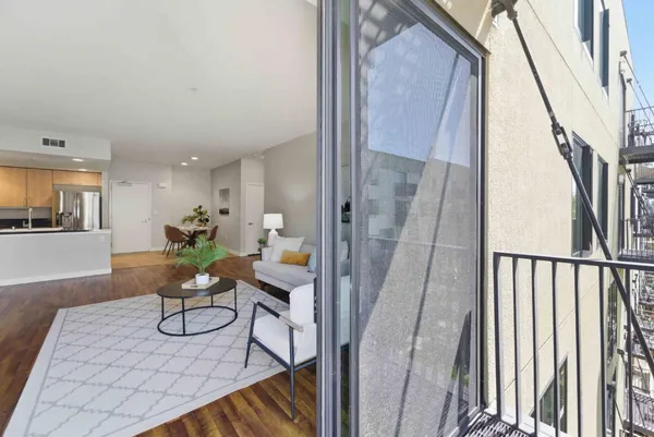 a view of a hallway with furniture and floor to ceiling window