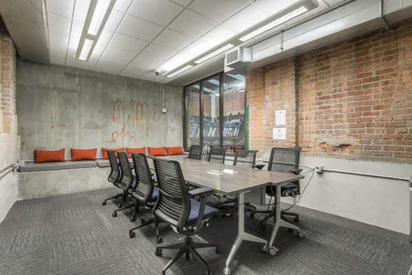 a dining hall with stainless steel appliances kitchen island granite countertop furniture and a fireplace