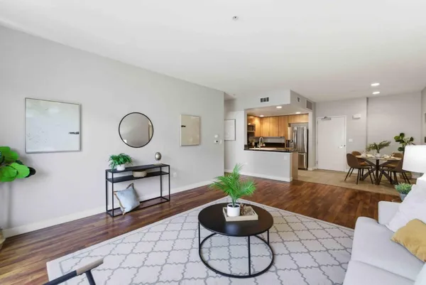a living room with furniture and a wooden floor