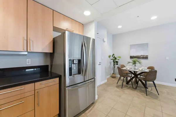 a kitchen with stainless steel appliances granite countertop a refrigerator and a stove top oven