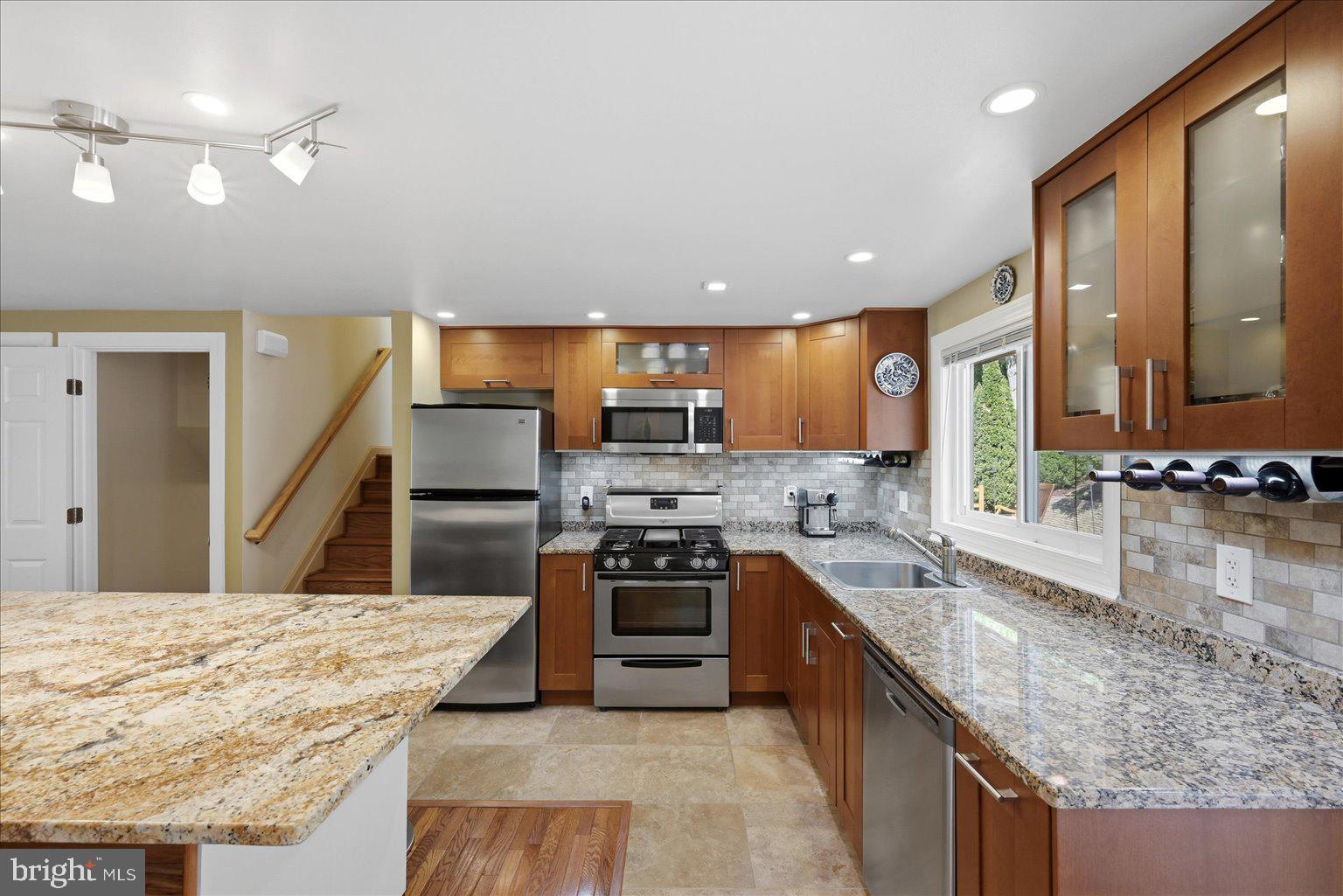10929 Howland Drive Reston, VA 20191 - Photo 8 of 66 a kitchen with stainless steel appliances granite countertop a stove and a sink