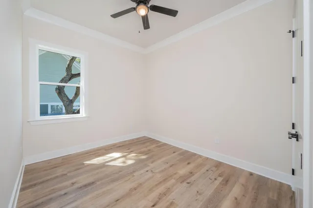 wooden floor in an empty room with a window
