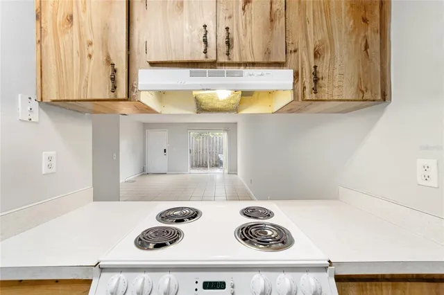 a kitchen with a stove a refrigerator and a sink