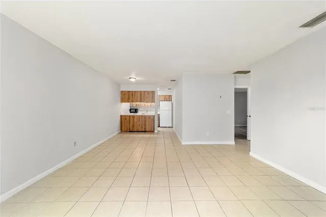 a view of a kitchen with a sink and a refrigerator in it