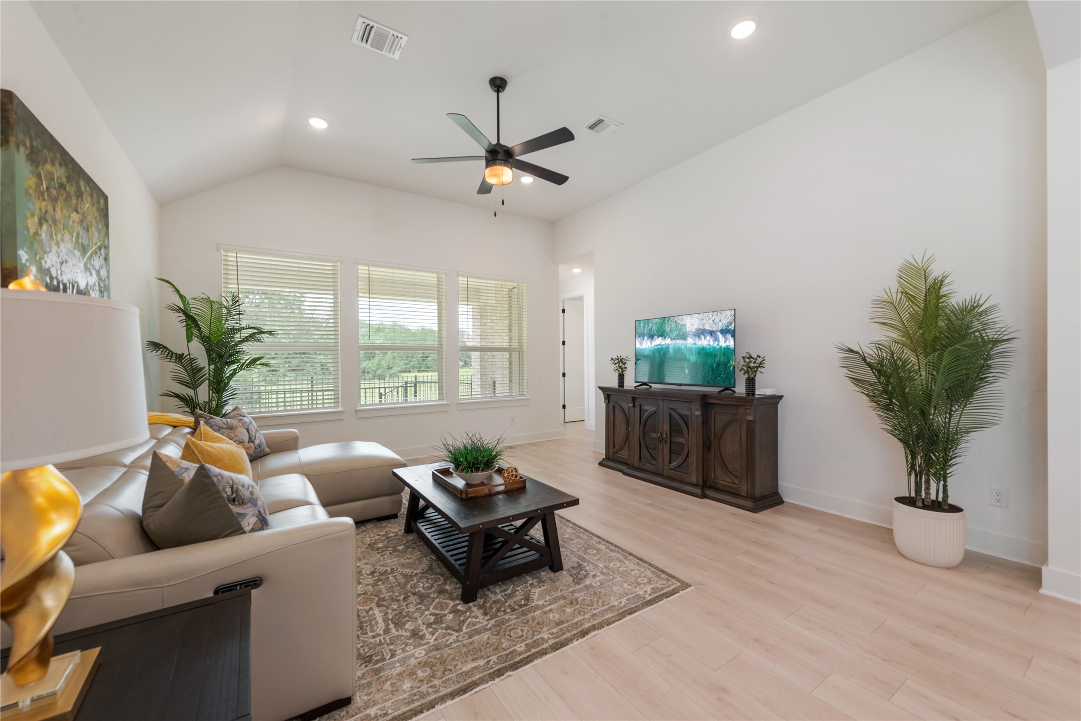 294 Kimble Creek Loop Kyle, TX 78640 - Photo 9 of 40 Natural light floods this living room, featuring soaring vaulted ceilings and light wood-tone flooring.