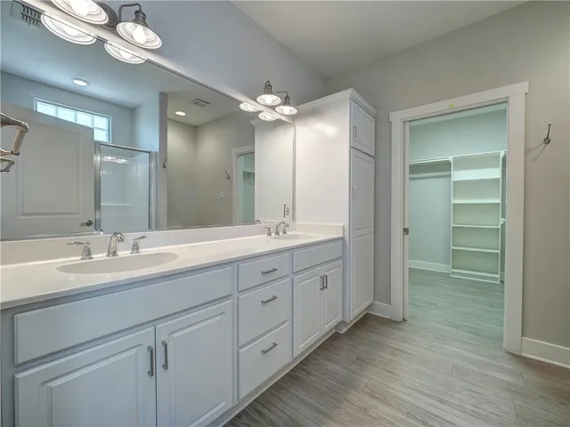 a bathroom with double vanity sinks and a mirror