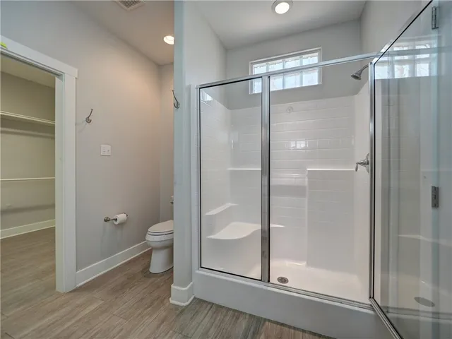 a bathroom that has a glass shower door