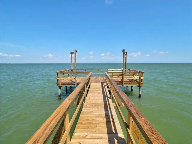 a view of a lake with a wooden deck