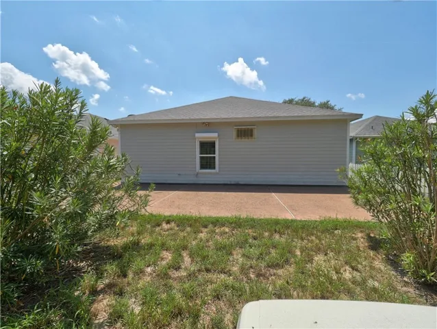a view of backyard of house with green space
