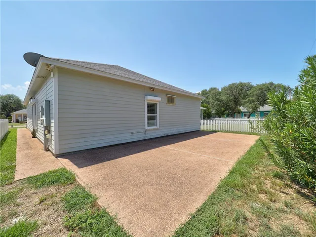 a backyard of a house with large trees