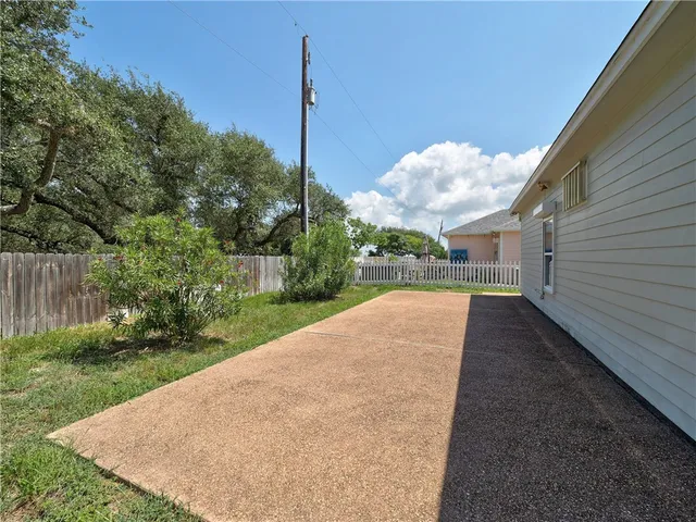 a view of a yard with a table and chairs